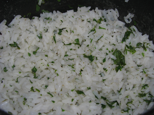 Fluff the rice. Add the cilantro, lime juice, sugar, salt and pepper.